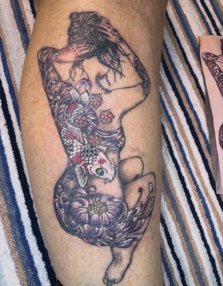 Woman with Japanese chrysanthemums and a koi on a calf